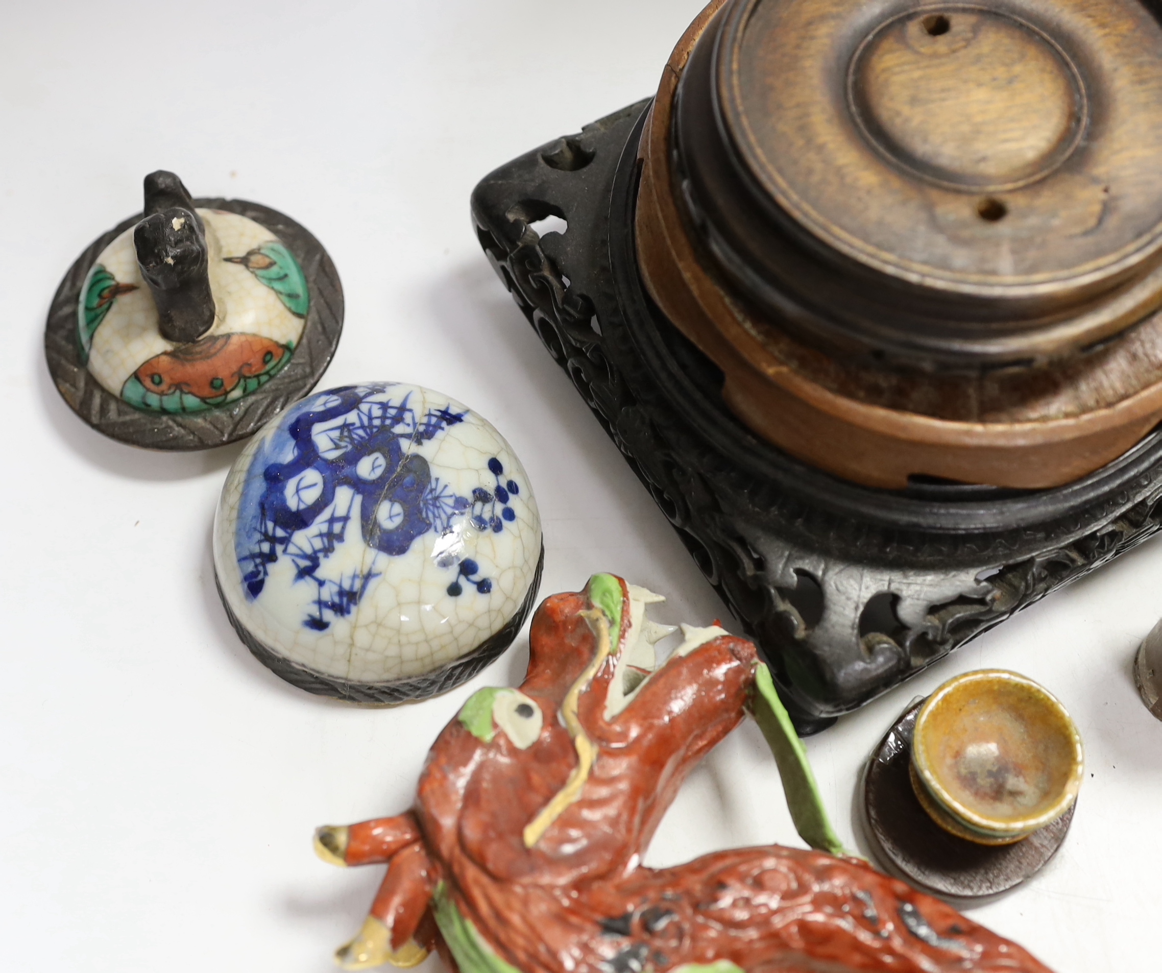 A collection of mixed Chinese wooden stands, a ceramic dragon head and miscellaneous ceramics